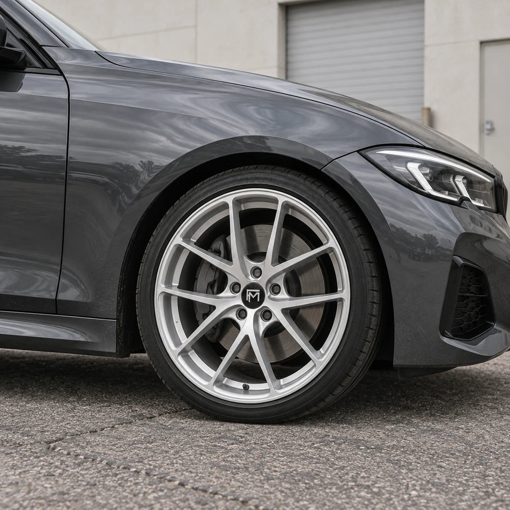 Editorial visualization of a silver wheel and graphite fender