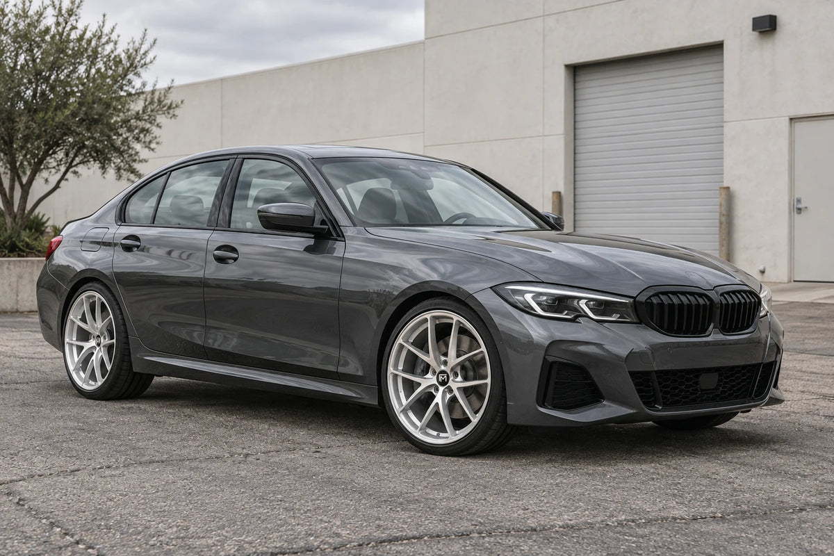 Editorial visualization of a graphite sedan with silver wheels in natural light