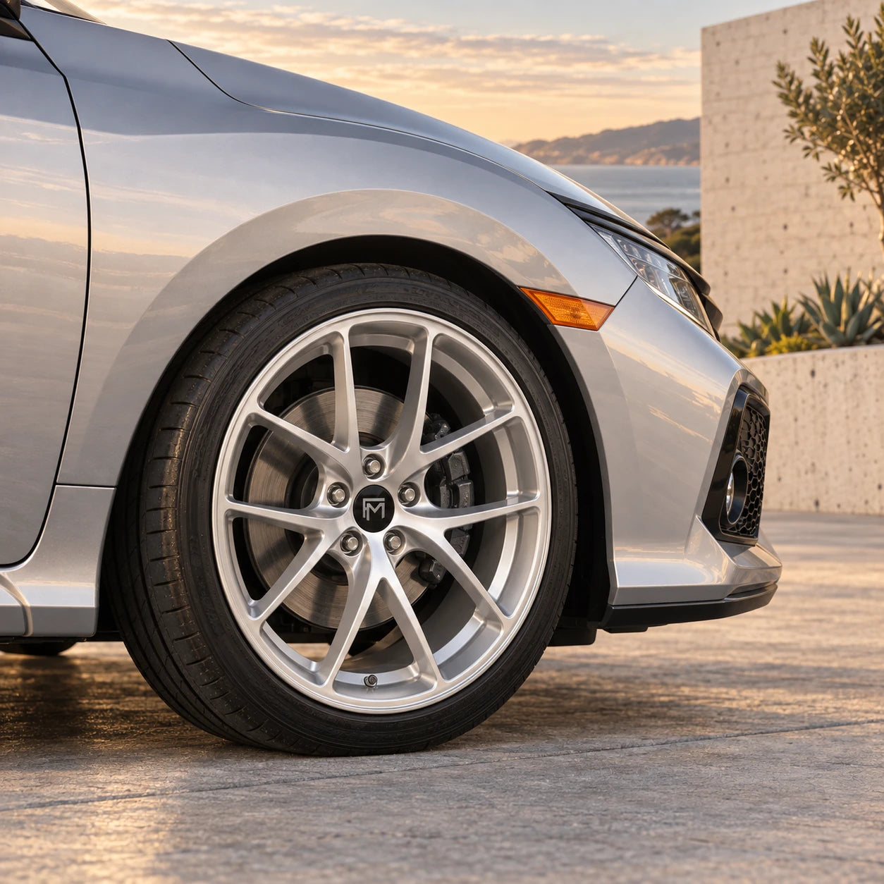 Concept close-up of a silver Stratos-style wheel against a Civic fender